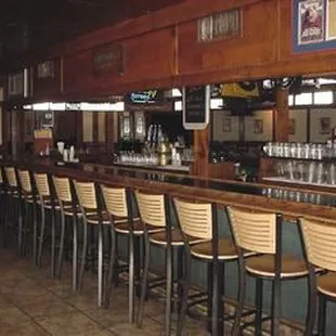 a row of chairs at a bar