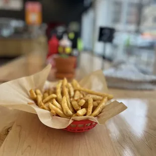 a basket of french fries on a table