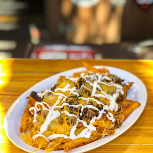 a plate of nachos on a wooden table