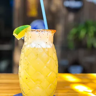 a pineapple drink on a table