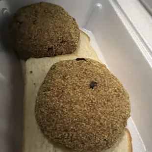 two sandwiches in a styrofoam container