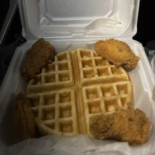 chicken and waffles in a styrofoam container