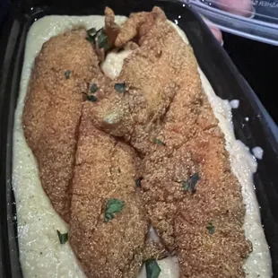 a fried fish fillet in a creamy sauce