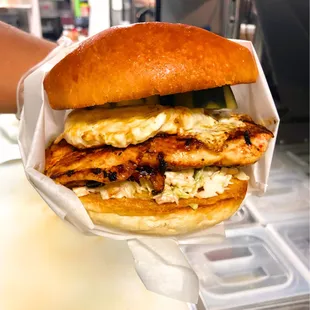 Dirty Byrd&apos;s Classic sandwich with juicy grilled chicken, crunchy coleslaw, tangy pickles, fried egg and the irresistible Dirty Byrd sauce.