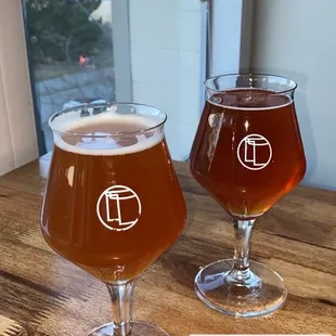 two glasses of beer on a table