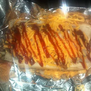 Boston Dog: bacon wrapped beef dog, grilled onion, baked beans, cheddar cheese and BBQ Sauce