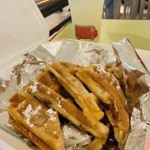 Hot sausage stuffed waffles with praline glaze and powdered sugar. My Petite Rouge Basil Lemonade peeking in the back.