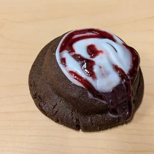 @endoedibles Instagram 08/30/24  Chocolate Raspberry Cookie - Triple Chocolate Cookie, White Chocolate Chips, Raspberry Filling, Icing