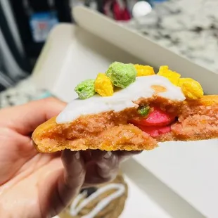 a hand holding a piece of food