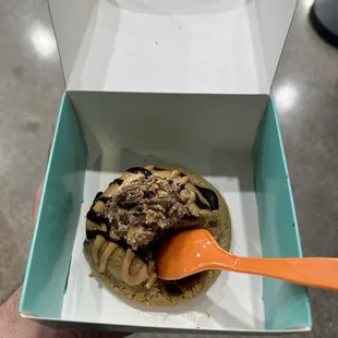 a person holding a spoon in a box