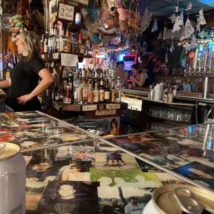 a woman behind a bar counter