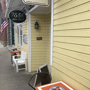 a table and chairs on the sidewalk