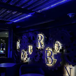 a dimly lit bar with blue lighting