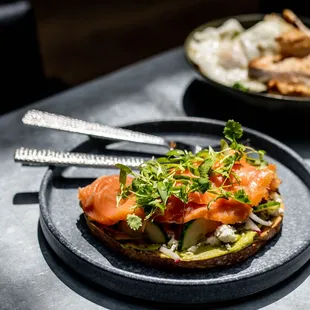 Avocado Toast // thick cut whole wheat toast, queso fresco, seasonal herbs, pickled heirloom tomato