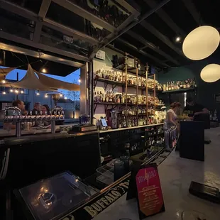 a bar with a lot of bottles of alcohol