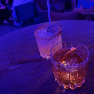 two glasses of alcohol on a table