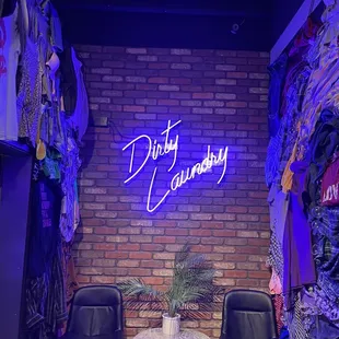 two chairs in front of a brick wall