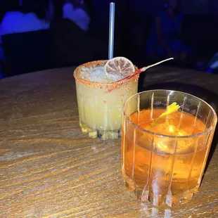 two cocktails on a wooden table