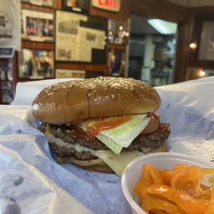 a burger and a bowl of chips