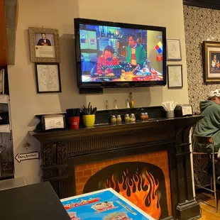 a man sitting at a bar watching tv