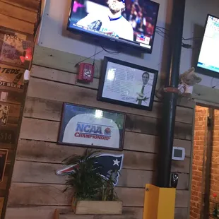a tv and a television screen in a restaurant