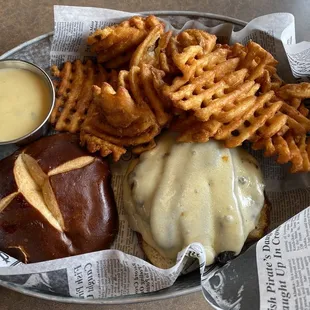 Mushroom and swiss burger on a pretzel bun with waffle fries and queso dip. Yum!