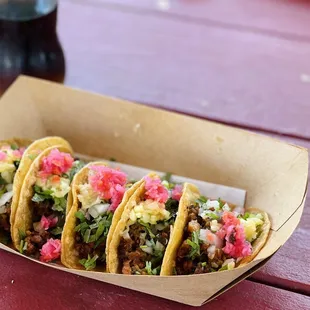 a tray of tacos on a picnic table