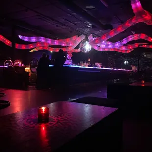 a bar with red and purple lights