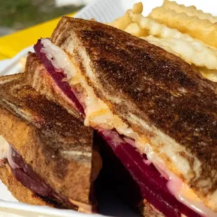 a grilled sandwich and french fries
