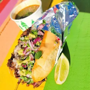 a sub sandwich and a cup of coffee