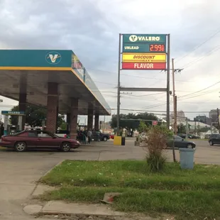 a gas station with cars parked in front of it