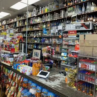 shelves of liquor and snacks in a store