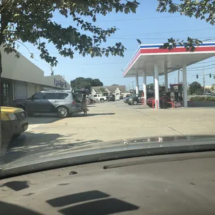 a view of a gas station from inside a car