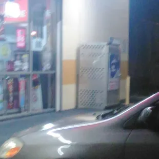 a car parked in front of a convenience store