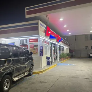 a black van parked in front of a gas station