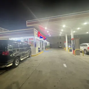 a black van parked in front of a gas station
