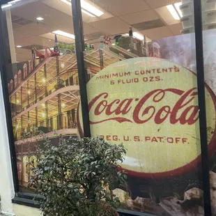 a coca cola advertisement in a store window