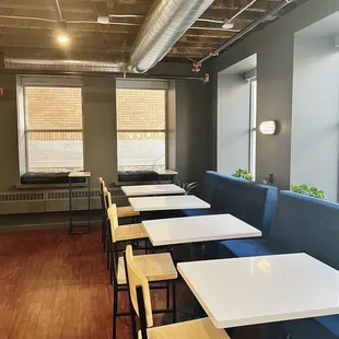 a row of tables and chairs in a coffee shop