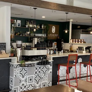 a coffee shop with black and white tiles