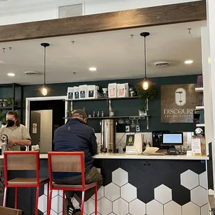 a man sitting at a counter in a restaurant