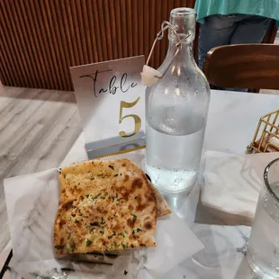 Love it when restaurants give you a container of water. Look at all the garlic on the garlic naan!! Love!
