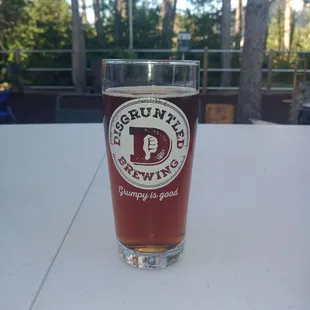 Patio with lovely pines-- there's ample seating, and a game area including a kiddie table.