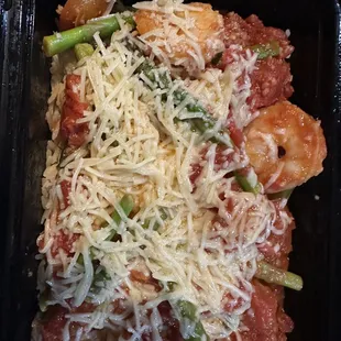 a close up of a pasta dish with cheese and asparagus