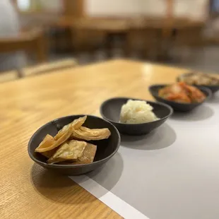 three bowls of food on a table