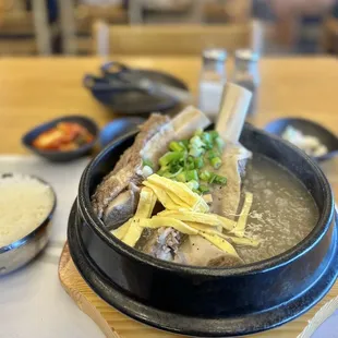 a bowl of soup with chopsticks