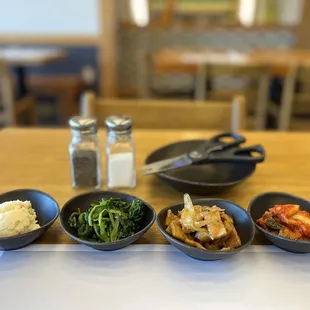 three bowls of food on a table