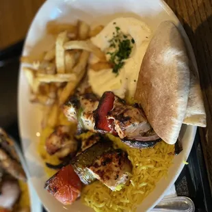 Chicken kebab with fries and garlic dip and pita bread