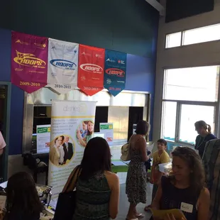 a group of people standing around a table
