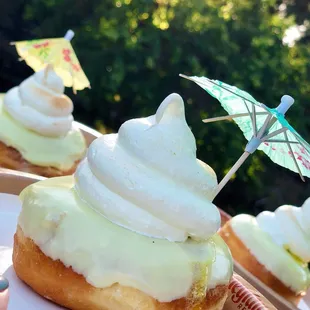 a cupcake topped with whipped cream and an umbrella