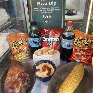 The cart sells not only the smoked turkey leg but also chips, corn, pepperoni pizza, and soda